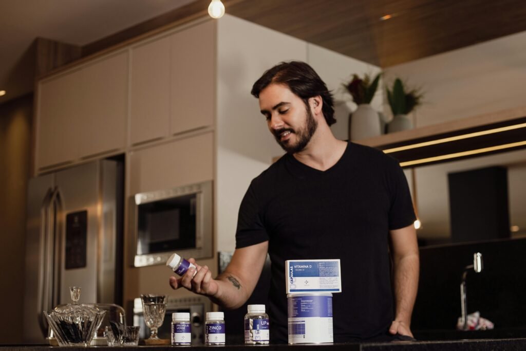 Man in a Kitchen and Bottles of Supplements on a Kitchen Countertop. muscle recovery
BCAA's