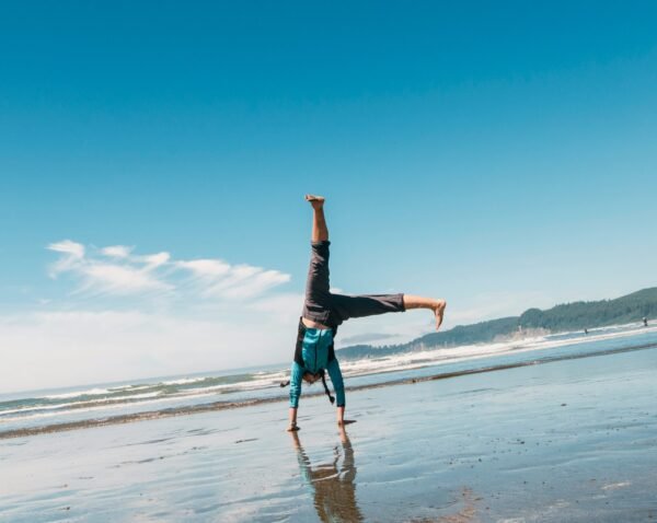 man doing a stunt on beach