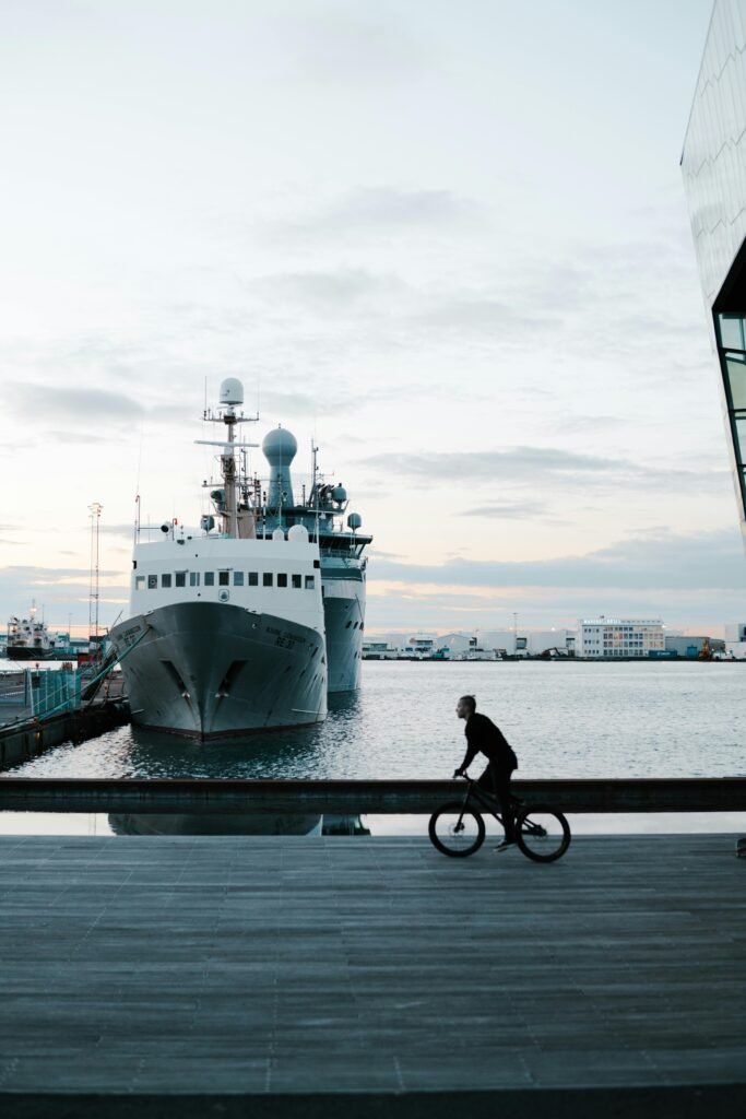 Man Riding Bicycle on Harbor. Rest day activities