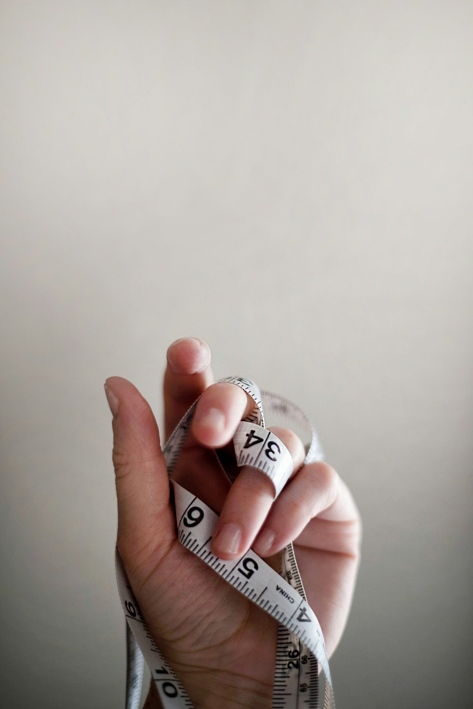 person's left hand wrapped by tape measure weight loss foods