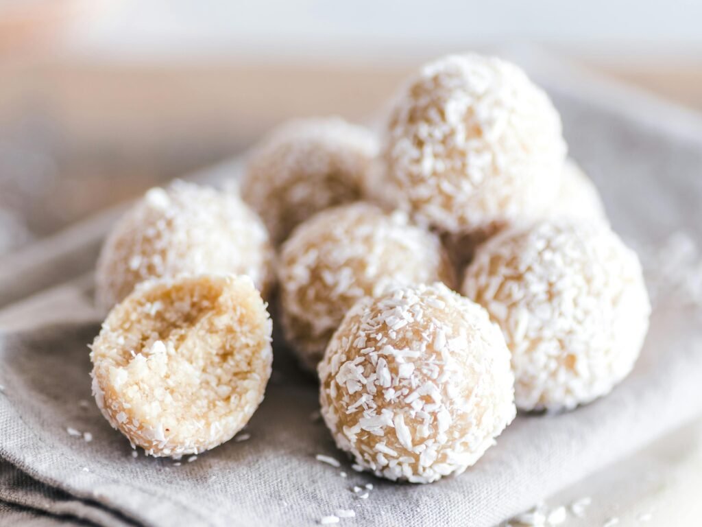 A close-up of coconut bliss balls on a linen cloth, showcasing their texture and sweet appeal.