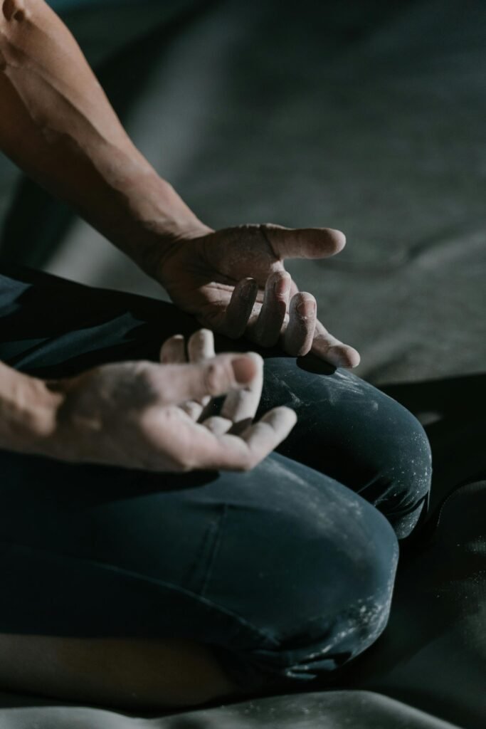 pexels-photo-6701946-6701946 Close-up of a climber's hands with chalk, preparing for bouldering.