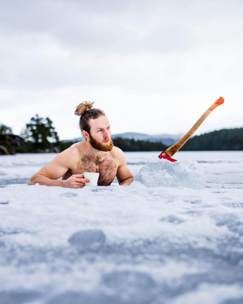 pexels-photo-14232280-14232280 Bearded man with an axe enjoys a cup of coffee during winter swim in Trondheim, Norway. Best Ice Bath for Large Athletes: Which Tub Actually Fits Bigger Builds?