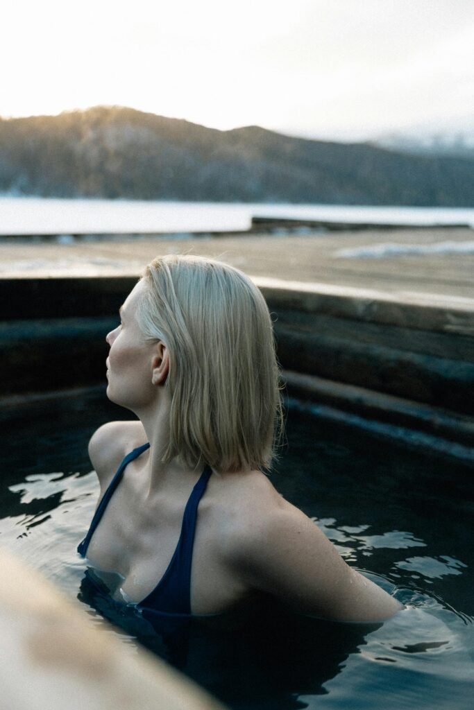 pexels-photo-20763181-20763181 A young woman relaxes in a hot spring during winter with scenic mountain views. The Best Affordable Ice Baths On Amazon: Recovery Tubs That Actually Work