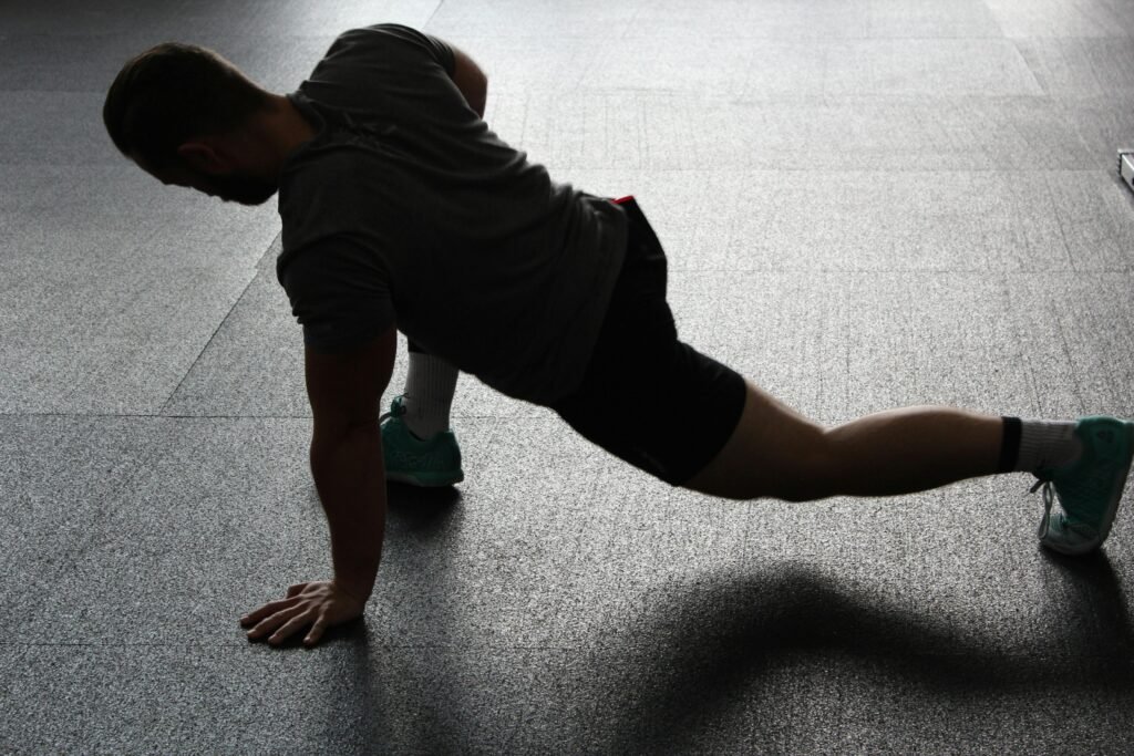 pexels-photo-209969-209969 Silhouette of a man executing a stretching routine in a dim gym environment. Top 5 Mobility Drills For Wrestlers: Drills Every Wrestler Should Do Before Practice