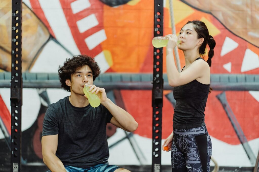 pexels-photo-4853718-4853718 Asian couple in activewear drinking yellow beverages at an indoor gym. Affordable Gym Clothing Brands That Still Deliver on Quality
